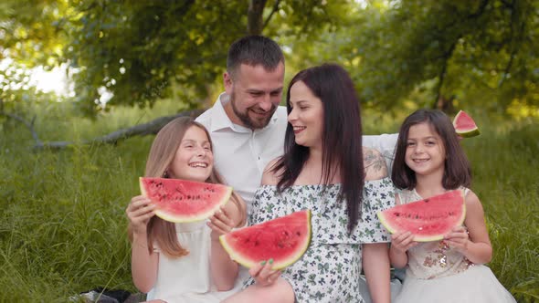 Happy Family with Kids Having Summer Picnic at Green Park