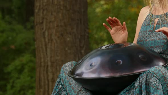 Beautiful Young Woman Plays a Hang in the Autumn Park