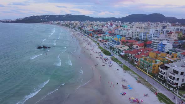 Aerial establishing shot of Bombas y Bombinhas with a colorful sunset in Brazil