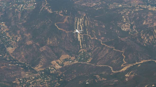 View From Plane Window Of A Near Fast Flying Passenger Plane Background Hills