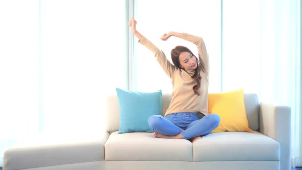 Asian woman sit on sofa and relax