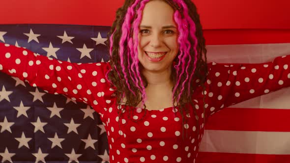 Young Woman with American Flag on Red Background