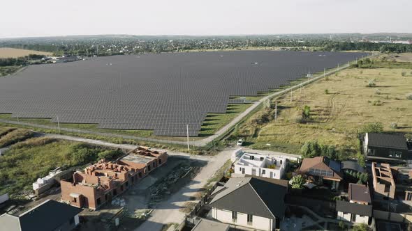 Establishing Shot of Cottage Township with Solar Photovoltaic Panels Arrays on the Roofs