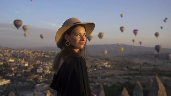 Happy Young Woman With Hat On Hot Air Balloons