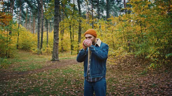 Calm Hiker Guy Drinking Hot Tea Travelling in Beautiful Autumn Forest Active Lifestyle Concept
