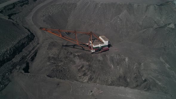 Top View to Career Walking Excavator Removes Waste Rock Digging Out Layer of Useful Material