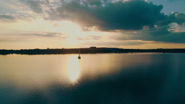 Aerial View One Yacht at Sunset Near the Barge