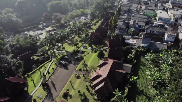 Cinematic overhead aerial view of suburban area located in puncak, Indonesia
