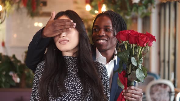 African Man Making Surprise for His Girlfriend on Valentine's Day at Restaurant