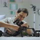 An Asian man is setting a camera rig - VideoHive Item for Sale