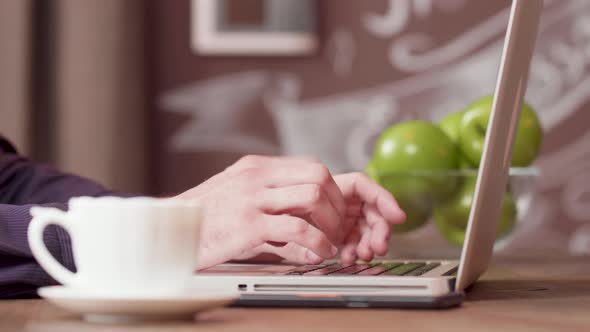 Male Hands While Working on a Laptop From a Local Bar