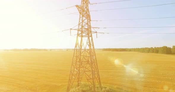 Vertical Movement Flight Near High Voltage Electricity Tower and Power Lines at Green and Yellow