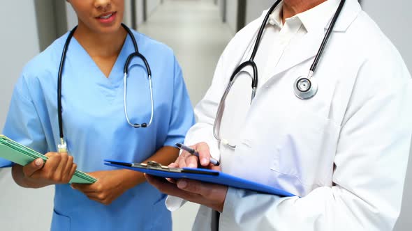 Doctors interacting with each other in corridor