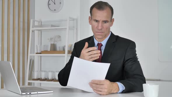 Wondering Middle Aged Businessman Astonished By Results