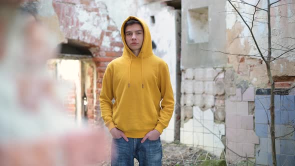 A teenager in an abandoned territory surrounded by dilapidated walls