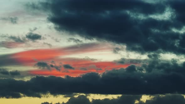 Brightcolored Sky with Clouds Floating Against Sunset