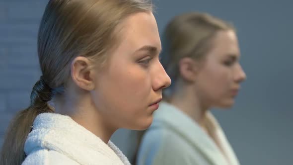 Ashamed Young Lady in Bathrobe Looking in Mirror, Low Self-Esteem Problems