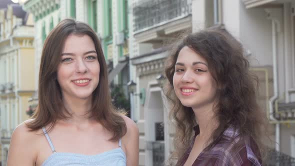 Happy Two Women Showing Heart Shape with Their Hands