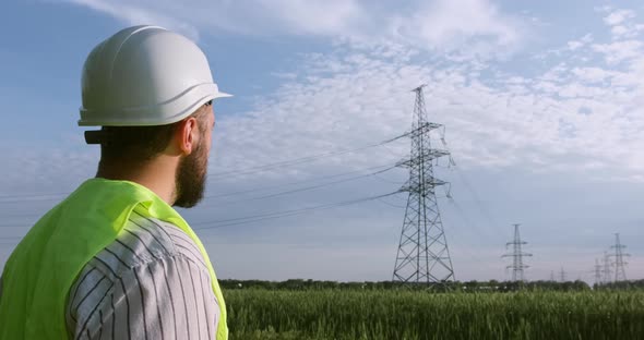 The power engineer looks at the power lines.