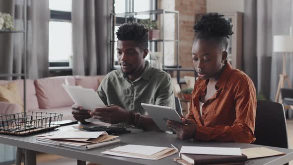 Couple Working on Tablet at Home