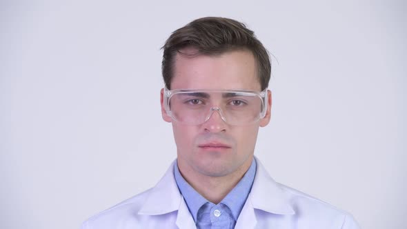 Young Happy Handsome Man Doctor Wearing Protective Glasses