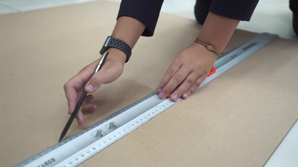 A Man Glues the Details of Crafts From Cardboard on the Desktop