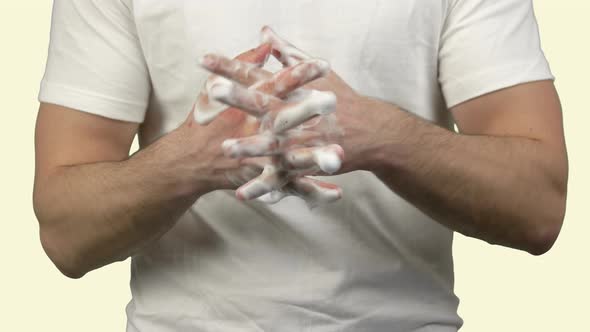 Young Man Washing His Hands with Soap Foam To Protect Them From Viruses and Bacteries