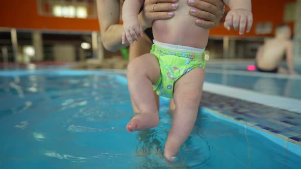 Mother Teaches Her Baby to Swim in a Closed Public Pool