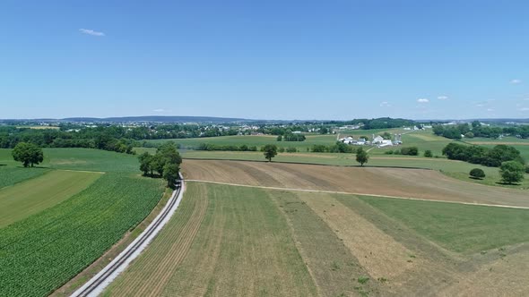 Aerial View of the Farm Countryside with a Single Rail Road Track on a Curve