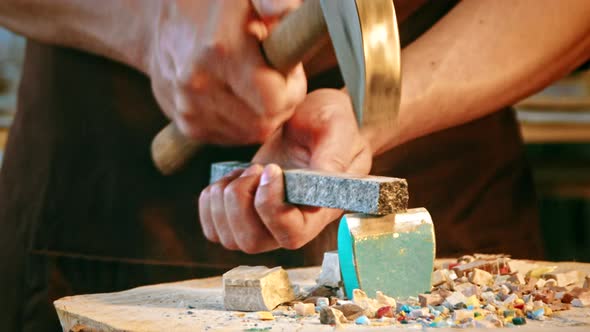 Mature man at work in studio close-up. Young man in an apron at work