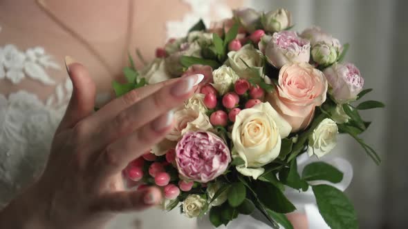 the Bride Holds a Wedding Bouquet in Her Hands