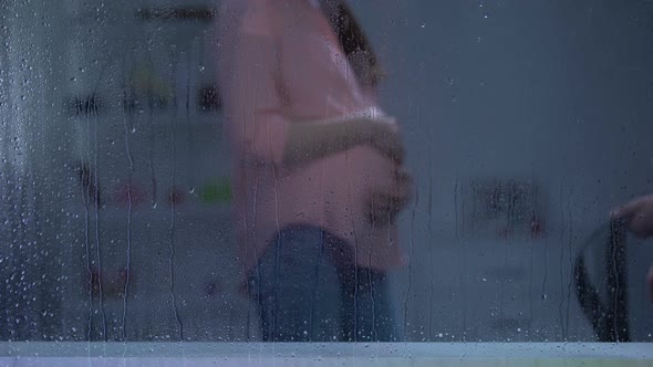 Man Threatening Pregnant Woman With Belt Behind Rainy Window, Family Assault