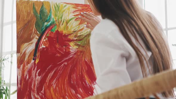 Woman Artist Draws Exotic Flower Touching Canvas By Finger