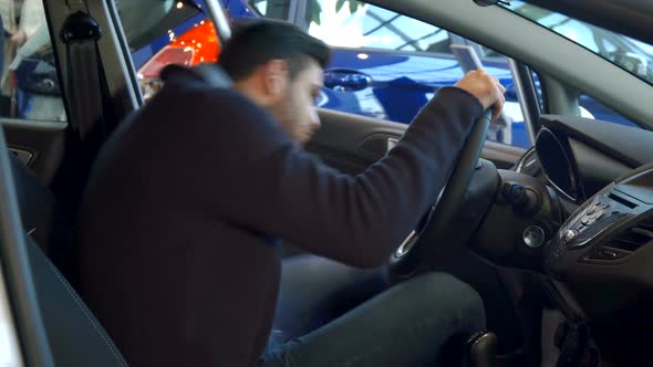 Man Fastens His Seat Belt in the Car