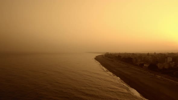 Silhouette of coast at sunset with fog