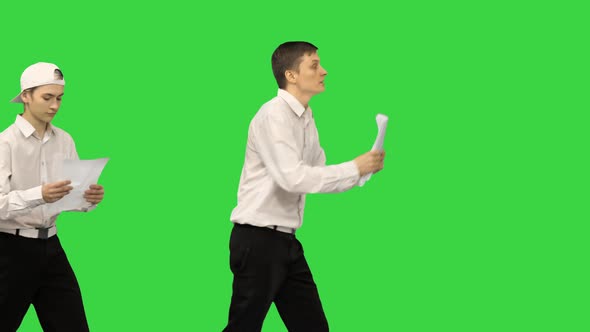 Three Guys Checking Documents While Dancing in a Row on a Green Screen, Chroma Key.