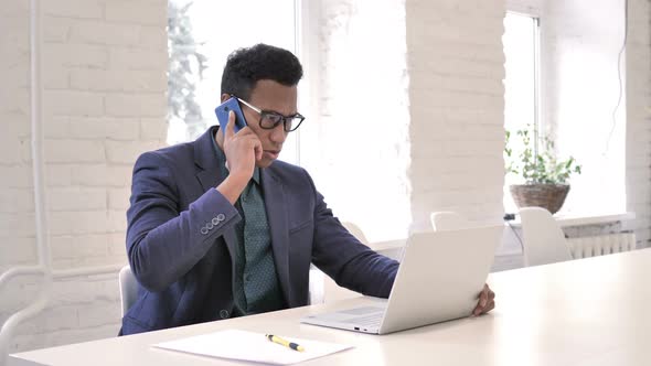 Businessman Talking on Phone, Negotiating with Customer