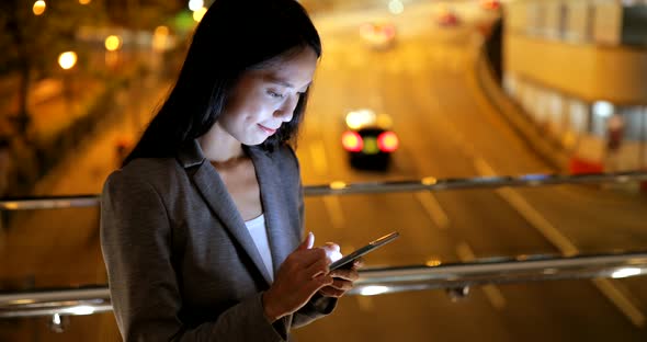 Business woman use of mobile phone at night 