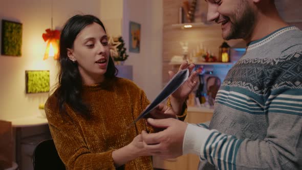 Man and Woman Preparing Christmas Card for Holiday Festivity