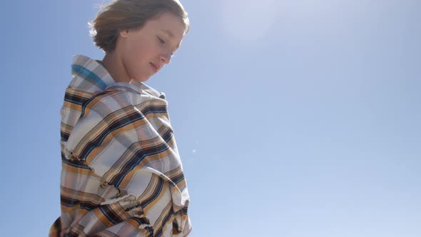 Teenage girl playing with blanket on beach 4k