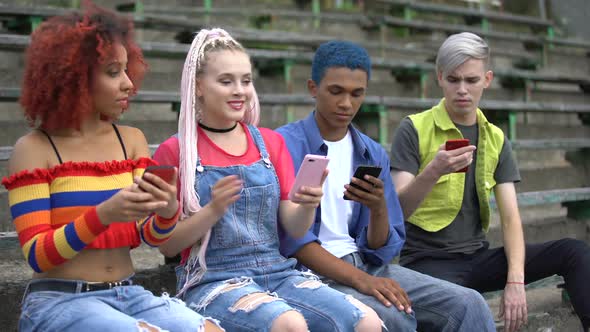 Young College Student Showing Social Network Post to Teen Friends, Millennial