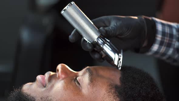 Male Barber Shaving Client Haircut in Barbershop