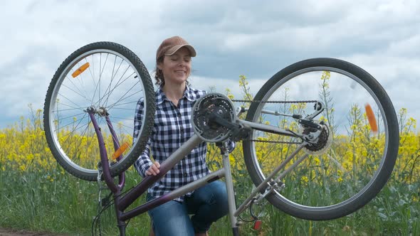 Woman repair a bike wheel. 