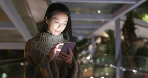 Woman use of mobile phone at night