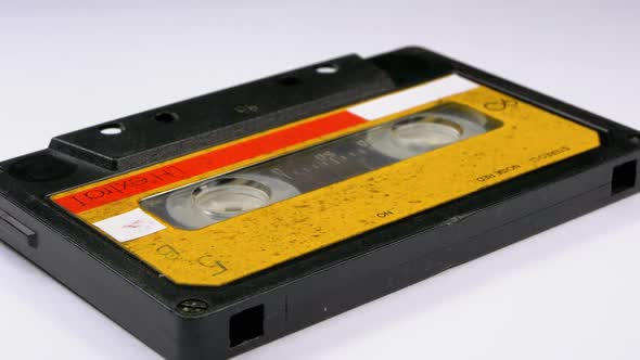 Audio Cassette Rotates on White Background