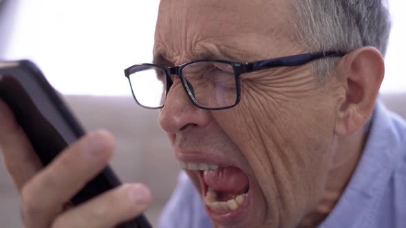 Angry Senior Businessman Shouting on the Phone He is Frustrated and Disappointed