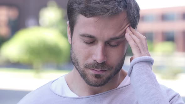 Tense Handsome Man with Headache Standing Outside Office