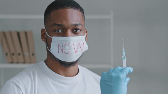 Afro Young Guy Patient Sick Black Man Wears Protective Medical Mask with Inscription No Vaccination