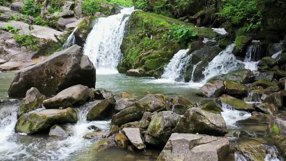 Mountain River Waterfall Flowing Between Rocky Shores in Carpathians Mountains Ukraine