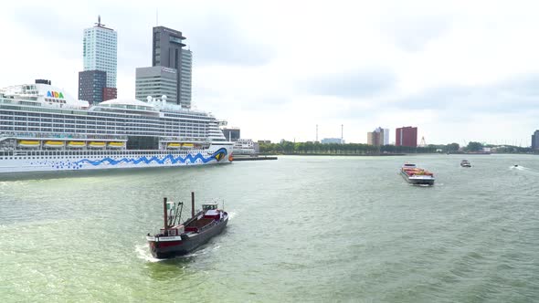 View from bridge on port of Rotterdam with small boats passing by